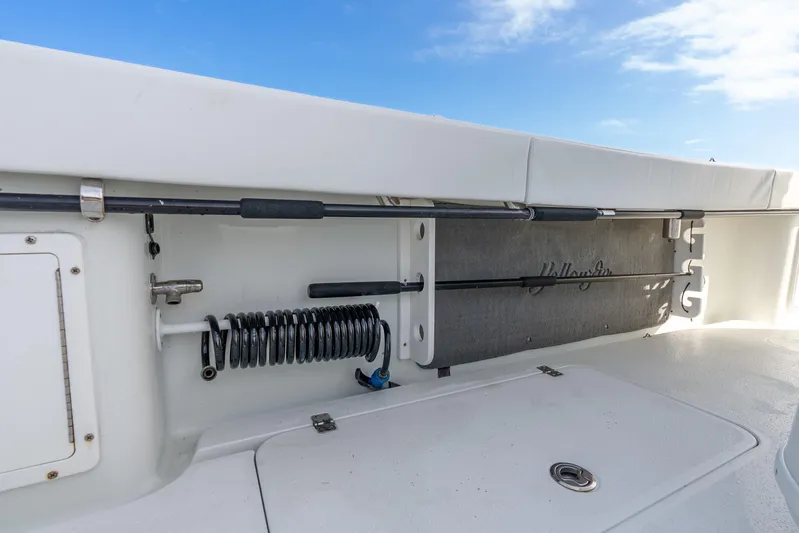  Yacht Photos Pics 2014 Yellowfin 32 Offshore boat interior with rod storage and coiled hose.