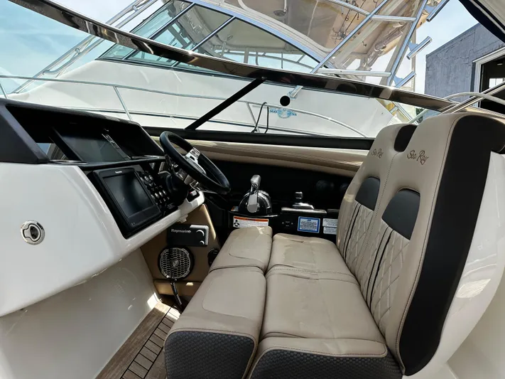 Nereids Yacht Photos Pics 2018 Sea Ray SLX 350 boat interior with steering wheel and seating area.
