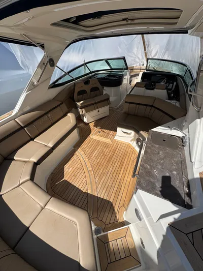 Nereids Yacht Photos Pics 2018 Sea Ray SLX 350 boat interior with tan seating and wood flooring.