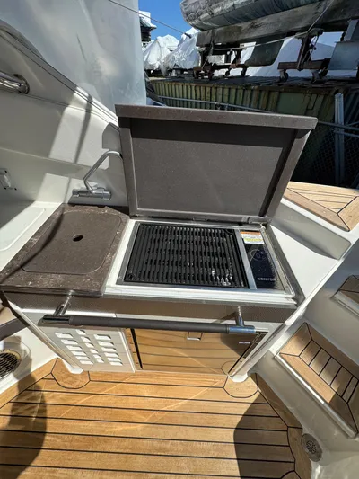 Nereids Yacht Photos Pics Outdoor kitchen on 2018 Sea Ray SLX 350 boat with grill and sink.