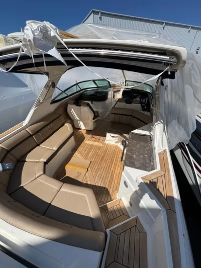 Nereids Yacht Photos Pics 2018 Sea Ray SLX 350 boat interior with tan seating and wood flooring.