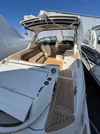 Nereids Yacht Photos Pics 2018 Sea Ray SLX 350 boat with spacious deck and seating, docked under clear blue sky.