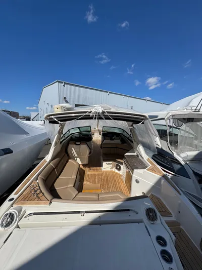 Nereids Yacht Photos Pics 2018 Sea Ray SLX 350 boat with spacious seating and sleek design under clear blue sky.