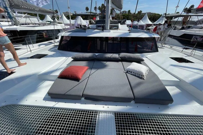 Knotty Cat Yacht Photos Pics 2022 Fountaine Pajot Tanna 47 catamaran with sunbathing cushions and pillows on deck.