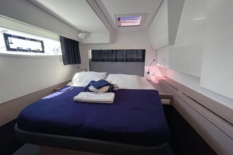 Knotty Cat Yacht Photos Pics Luxurious cabin interior of 2022 Fountaine Pajot Tanna 47 yacht with cozy bedding.
