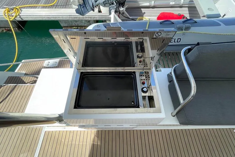 Knotty Cat Yacht Photos Pics Outdoor grill on 2022 Fountaine Pajot Tanna 47 yacht deck, near seating area.
