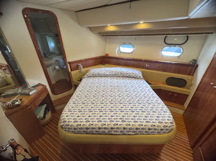  Yacht Photos Pics Luxurious bedroom interior of a 2000 Ferretti Yachts 620 with nautical decor.