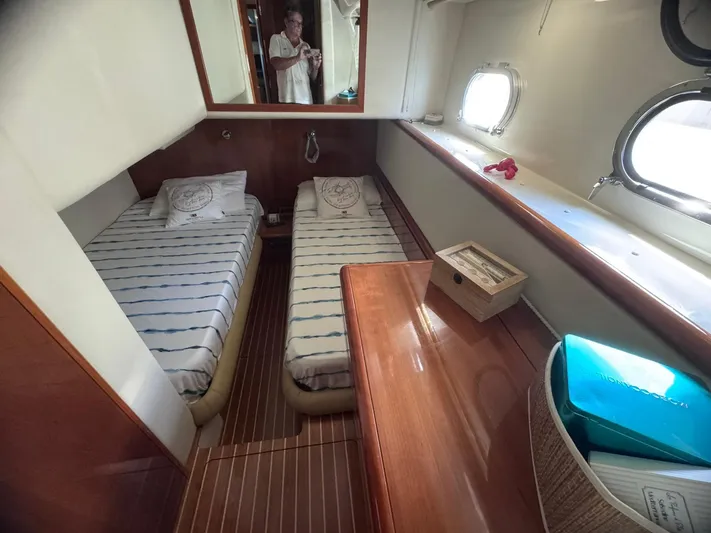  Yacht Photos Pics Interior cabin of 2000 Ferretti Yachts 620 with twin beds and wooden furnishings.