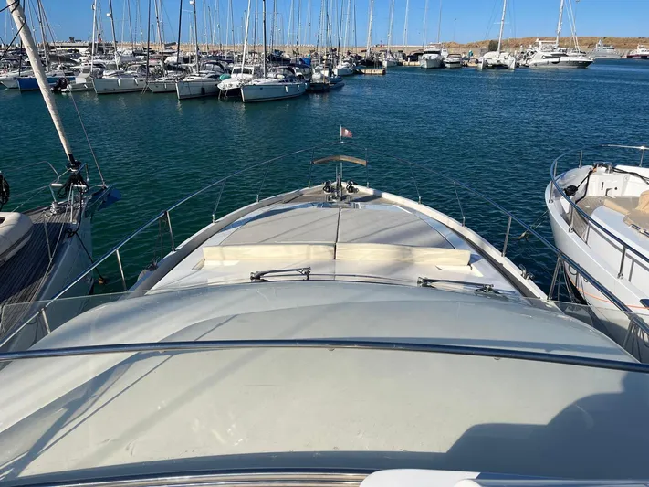  Yacht Photos Pics Ferretti Yachts 620, 2000 model, docked in a marina with sailboats.