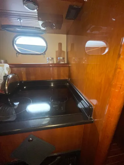  Yacht Photos Pics Luxurious kitchen area in a 2000 Ferretti Yachts 620, featuring a sleek stovetop.
