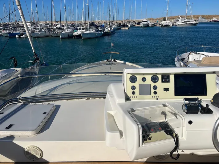  Yacht Photos Pics Control panel of a 2000 Ferretti Yachts 620 overlooking a marina with sailboats.