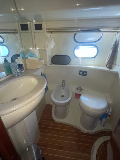  Yacht Photos Pics Bathroom interior of a 2000 Ferretti Yachts 620, featuring sink, bidet, and toilet.