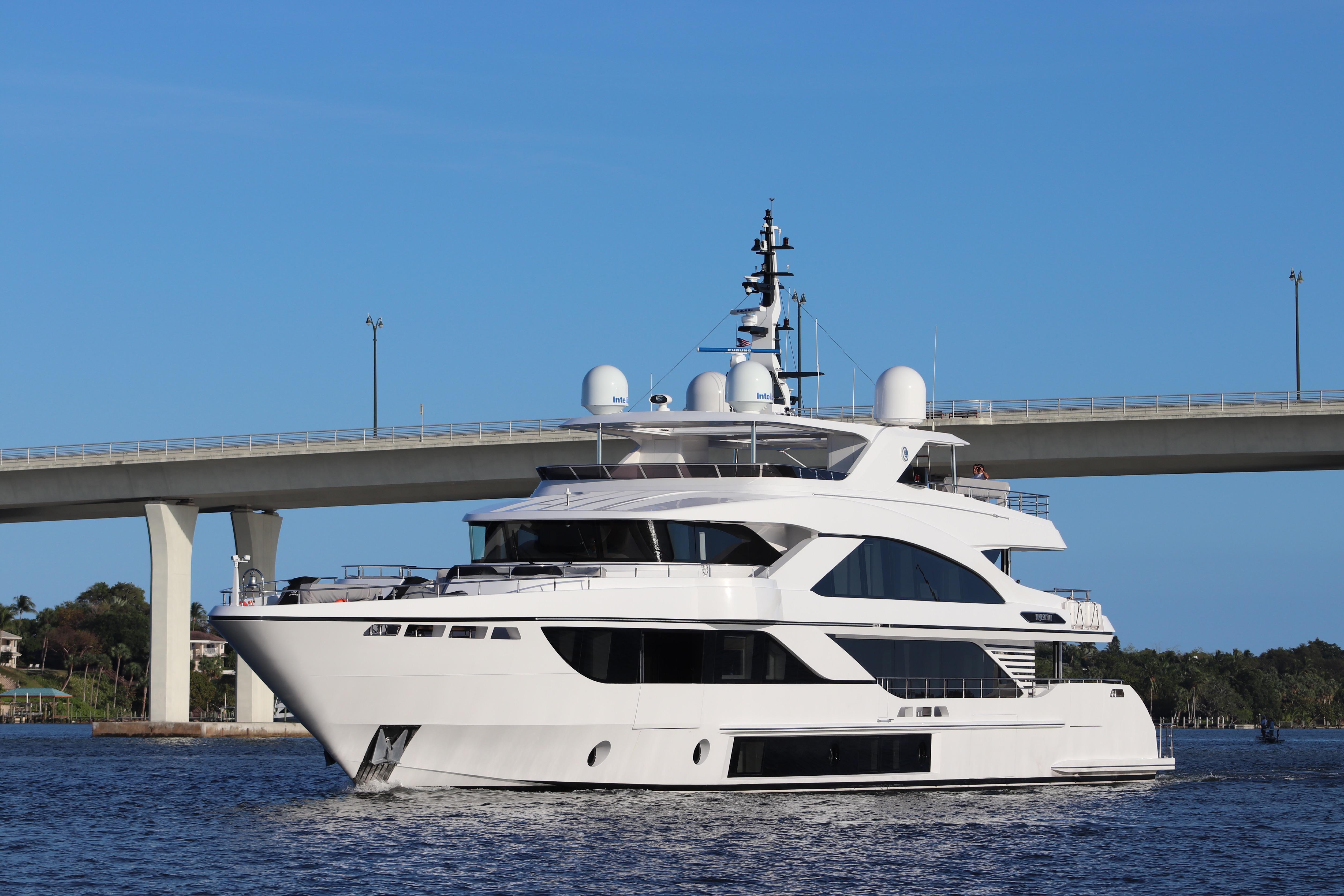 Luxury Majesty 140 yacht cruising under a bridge, 2020 model.