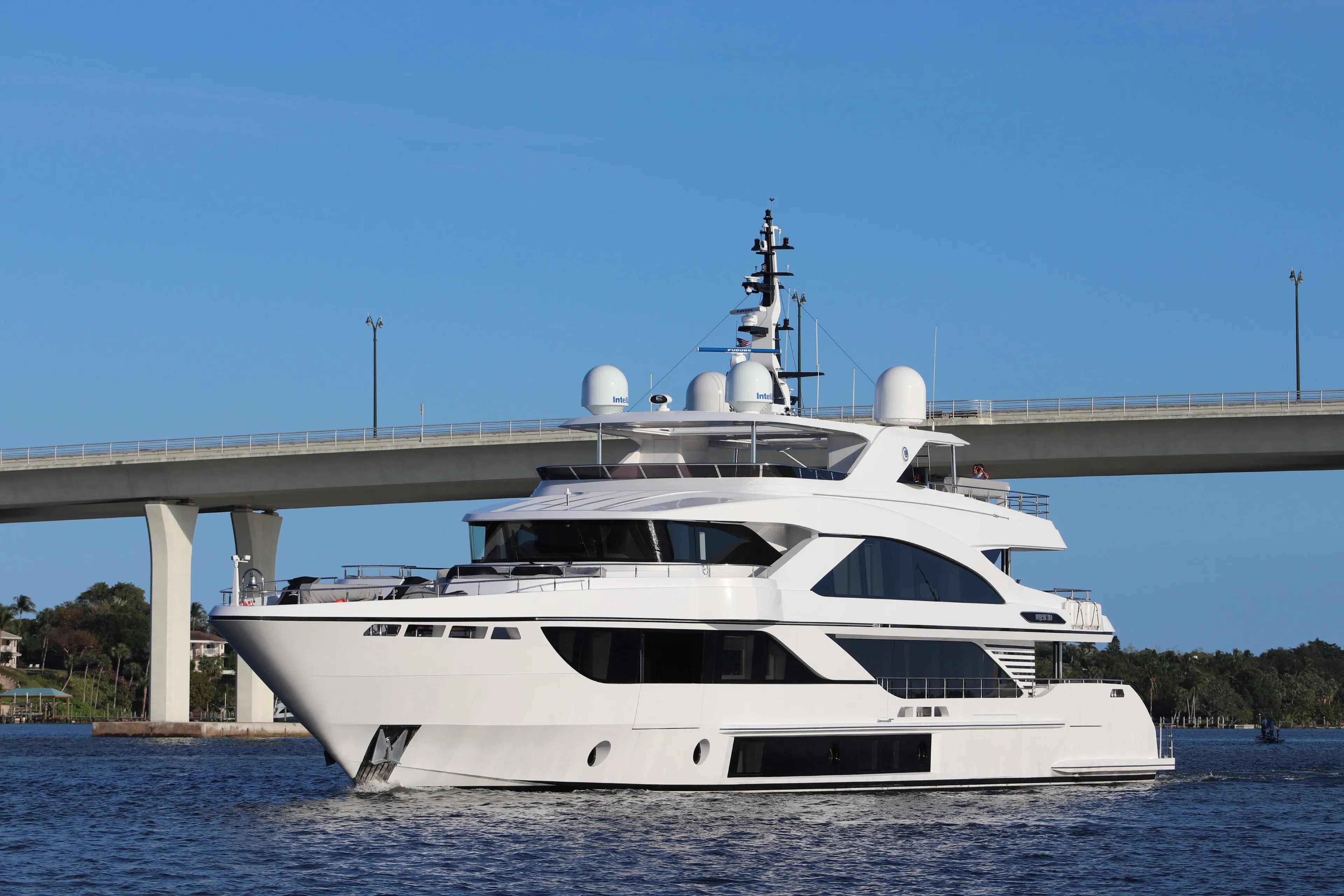 Luxury Majesty 140 yacht cruising under a bridge, 2020 model.