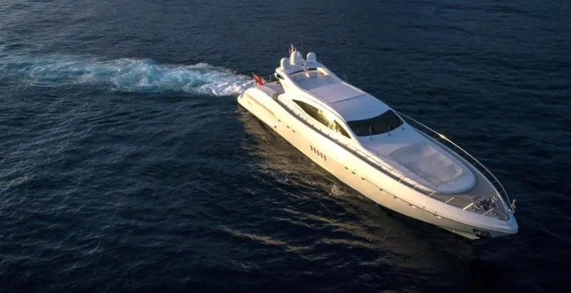  Yacht Photos Pics Luxurious 2004 Mangusta 108 yacht cruising on open water at sunset.