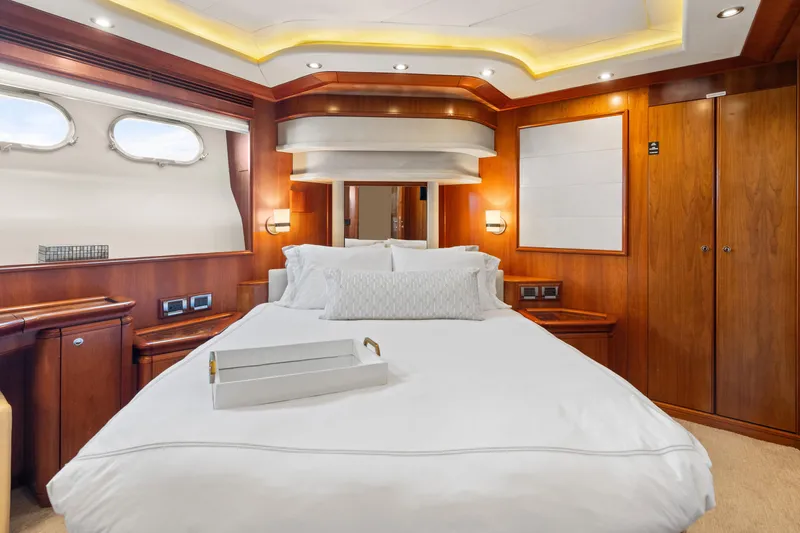Mambo Yacht Photos Pics Luxurious bedroom interior of 2004 Ferretti Yachts 112 Custom Line with elegant wood finishes.