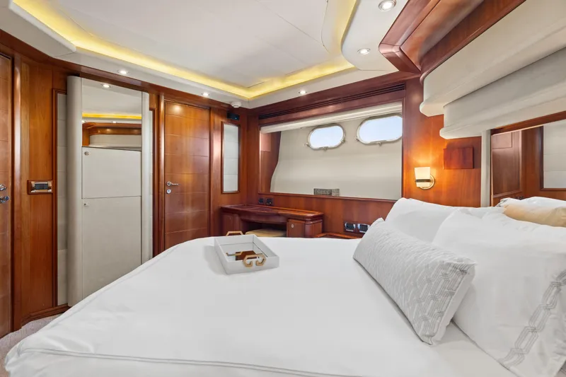 Mambo Yacht Photos Pics Luxurious bedroom interior of 2004 Ferretti Yachts 112 Custom Line with elegant wood finishes.