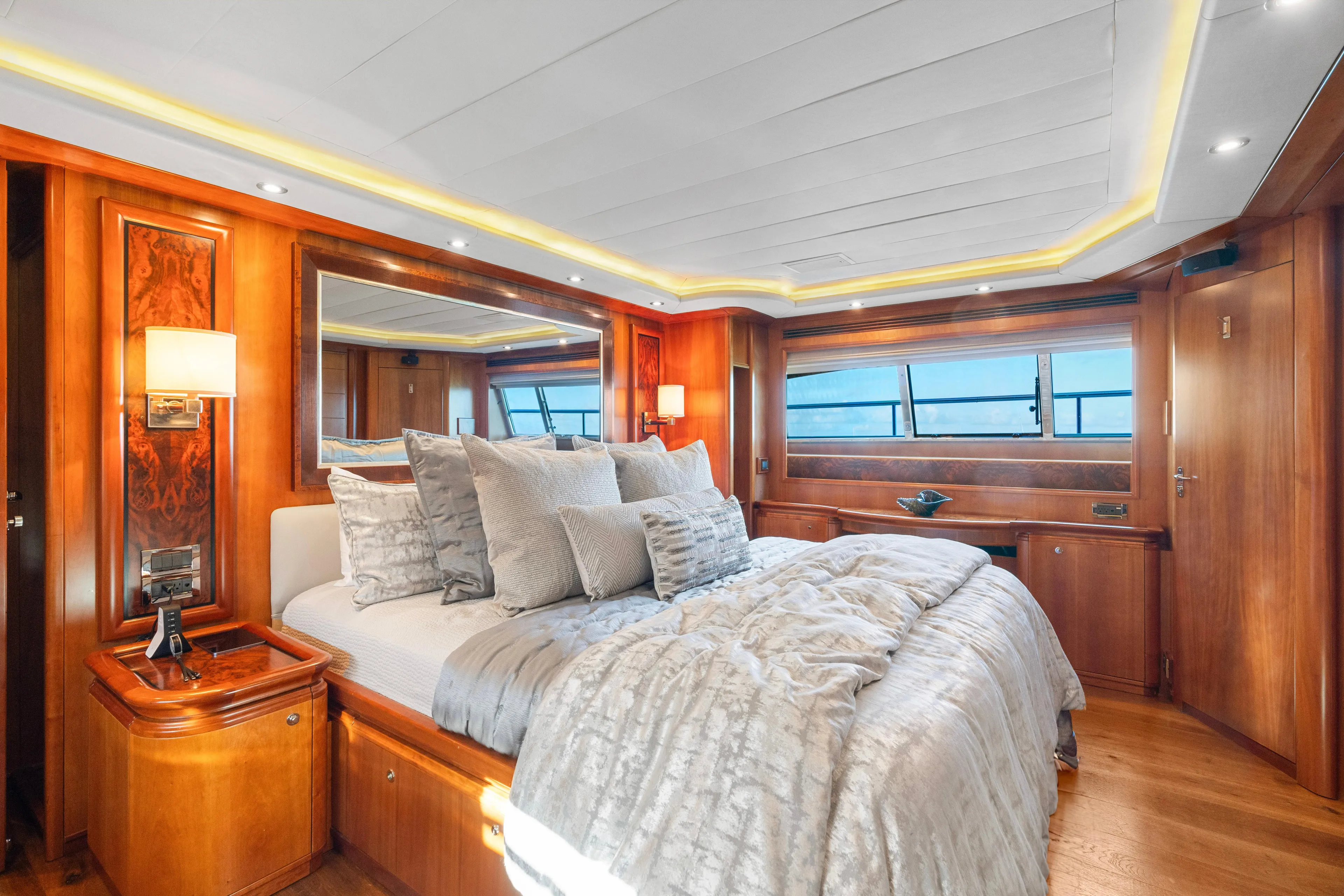 Mambo Yacht Photos Pics Luxurious bedroom interior on 2004 Ferretti Yachts 112 Custom Line, featuring elegant wood finishes.