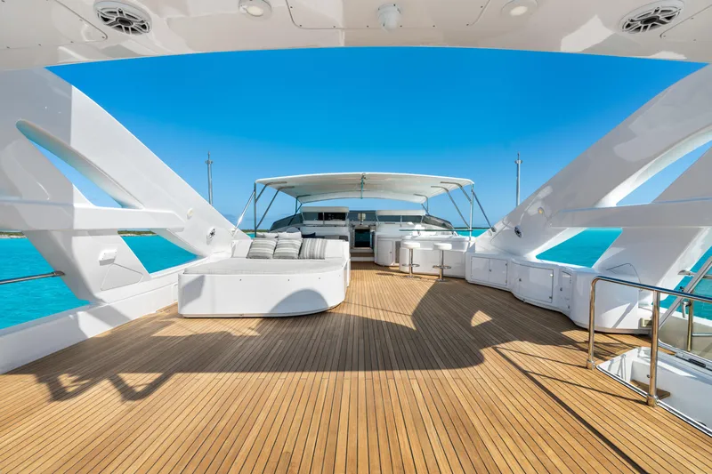 Mambo Yacht Photos Pics Luxurious 2004 Ferretti Yachts 112 Custom Line deck with seating, overlooking turquoise waters.