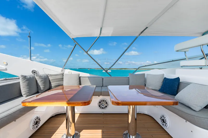 Mambo Yacht Photos Pics Luxurious deck seating on 2004 Ferretti Yachts 112 Custom Line, overlooking turquoise waters.
