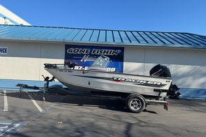 2018 Tracker Pro Guide V-165 WT boat on trailer outside fishing store.