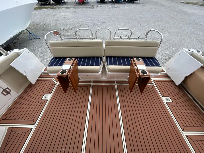  Yacht Photos Pics 2023 Ranger Tugs R-43 CB boat deck with cushioned seating and wooden flooring.