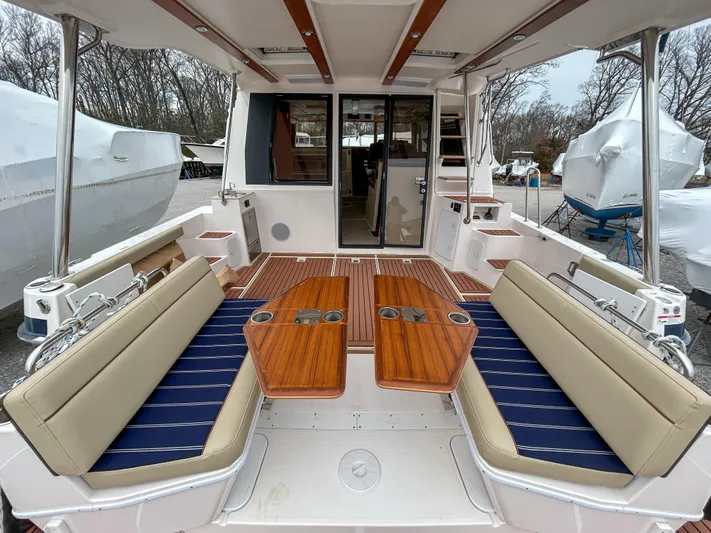  Yacht Photos Pics 2023 Ranger Tugs R-43 CB boat interior with seating and wooden tables.