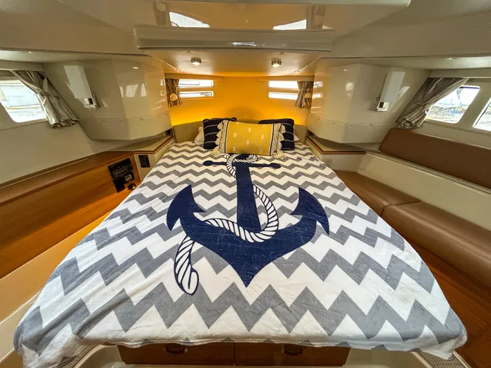  Yacht Photos Pics 2023 Ranger Tugs R-43 CB cabin with anchor-themed bedding and cozy interior design.