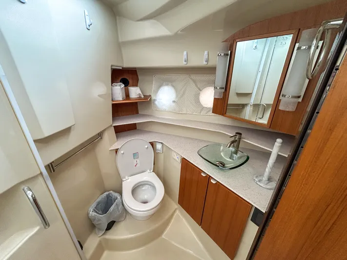  Yacht Photos Pics 2023 Ranger Tugs R-43 CB bathroom with modern fixtures and wood cabinetry.