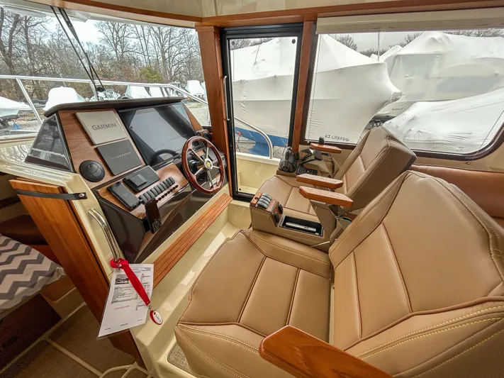  Yacht Photos Pics 2023 Ranger Tugs R-43 CB helm with leather seats and modern navigation equipment.