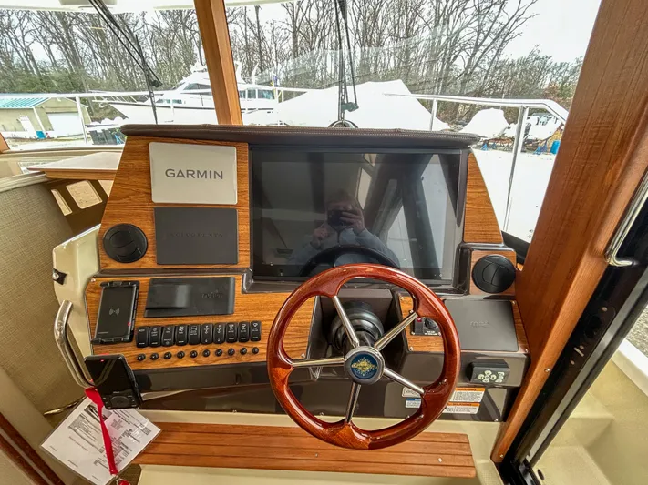 Yacht Photos Pics 2023 Ranger Tugs R-43 CB helm with Garmin navigation system and wooden steering wheel.
