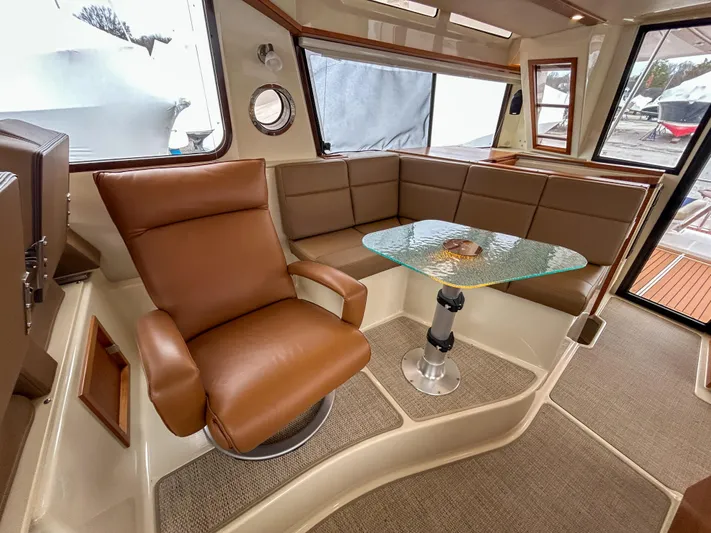  Yacht Photos Pics 2023 Ranger Tugs R-43 CB interior with leather seating and glass table.
