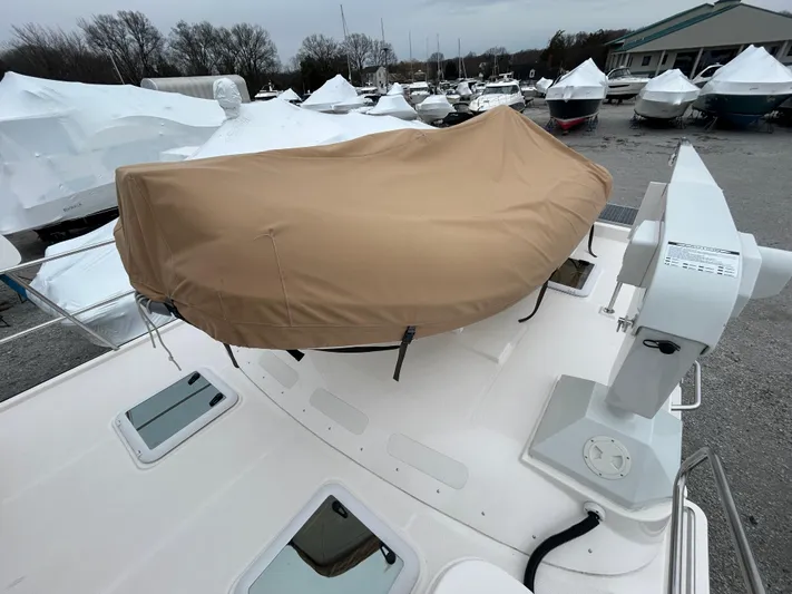  Yacht Photos Pics 2023 Ranger Tugs R-43 CB boat with covered equipment on deck, surrounded by other boats.