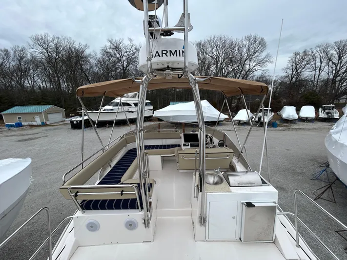  Yacht Photos Pics 2023 Ranger Tugs R-43 CB boat with spacious deck and seating area, parked outdoors.