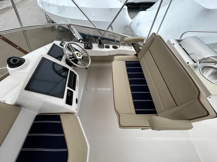  Yacht Photos Pics 2023 Ranger Tugs R-43 CB helm with dual screens and beige seating.