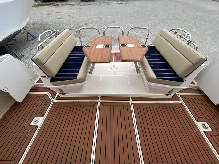  Yacht Photos Pics 2023 Ranger Tugs R-43 CB boat deck with cushioned seating and wooden tables.