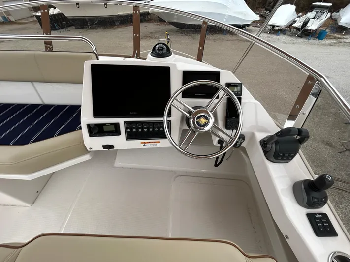  Yacht Photos Pics 2023 Ranger Tugs R-43 CB helm with steering wheel, navigation screens, and controls.