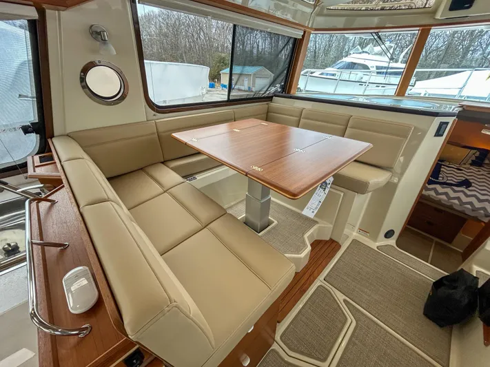  Yacht Photos Pics 2023 Ranger Tugs R-43 CB interior with beige seating and wooden table.