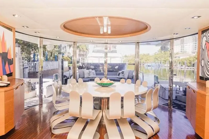 Intervention Yacht Photos Pics Luxurious interior of 2010 Azimut 100 Leonardo yacht with modern dining area and scenic views.