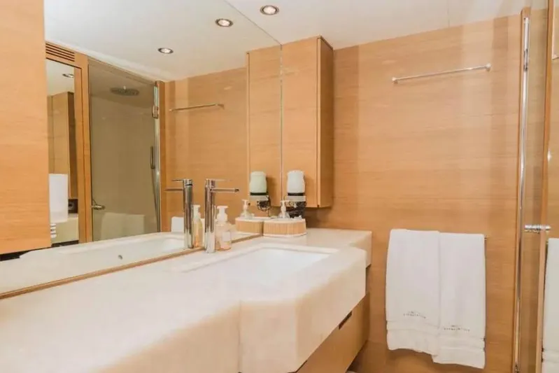 Intervention Yacht Photos Pics Luxurious bathroom on 2010 Azimut 100 Leonardo yacht with modern fixtures and wooden accents.