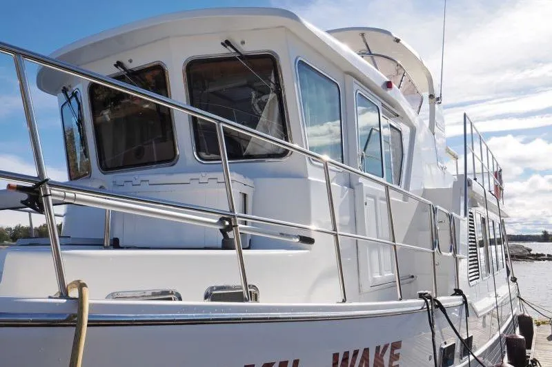 Sharki's Wake Yacht Photos Pics 2016 North Pacific 45 Pilothouse yacht docked under a clear sky.