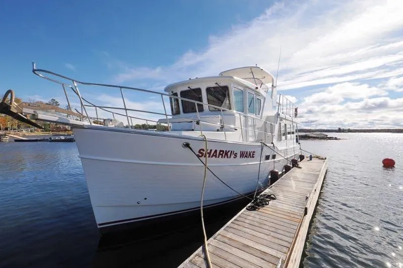 Sharki's Wake Yacht Photos Pics 2016 North Pacific 45 Pilothouse yacht docked on a sunny day.
