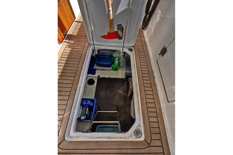 Sharki's Wake Yacht Photos Pics Storage compartment on 2016 North Pacific 45 Pilothouse boat with various tools and supplies.
