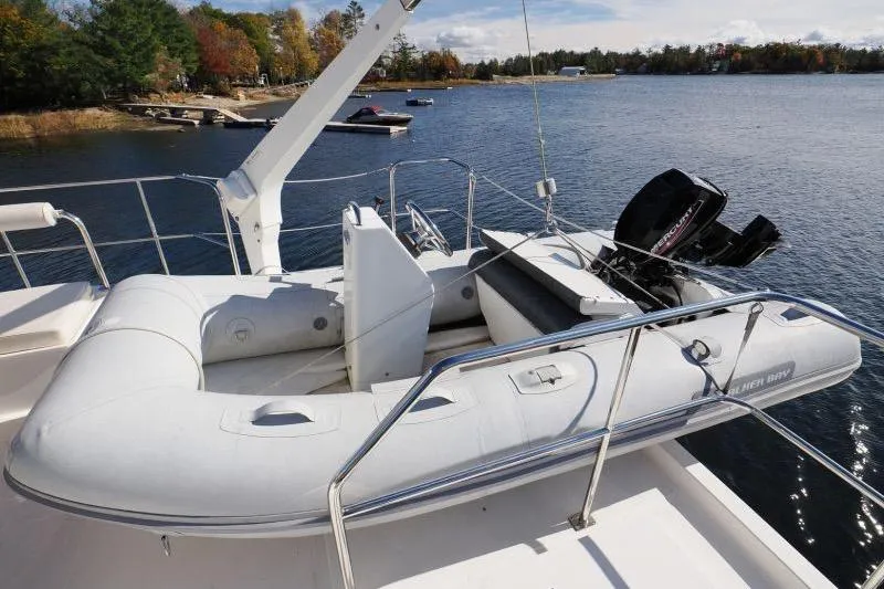 Sharki's Wake Yacht Photos Pics Inflatable boat on North Pacific 45 Pilothouse yacht, 2016 model, docked by a scenic lake.