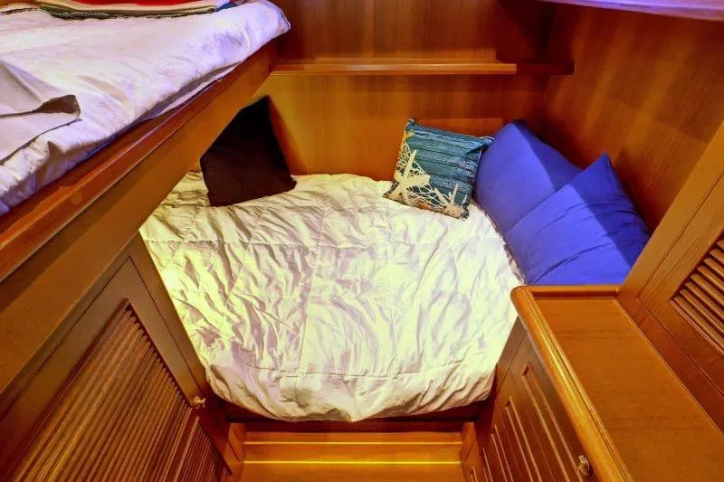 Sharki's Wake Yacht Photos Pics Cozy cabin bed with pillows in 2016 North Pacific 45 Pilothouse yacht.