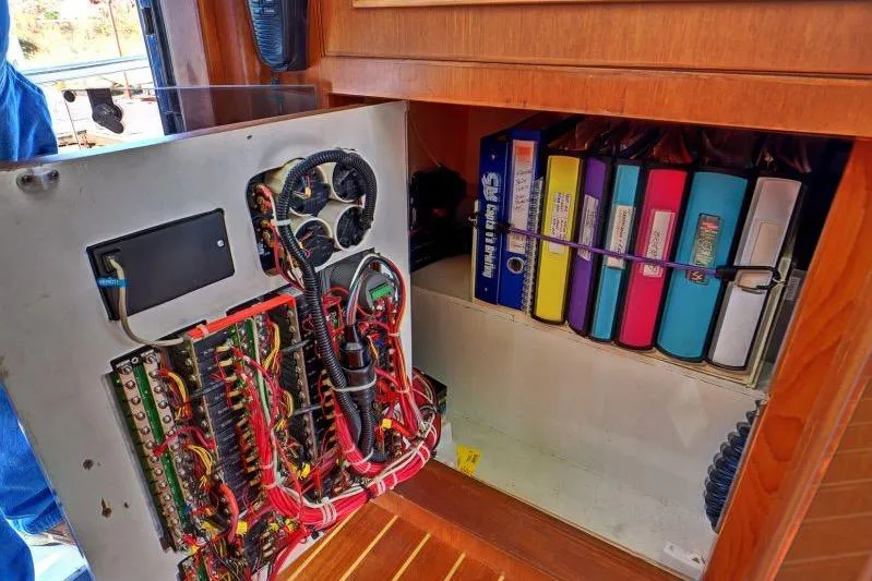Sharki's Wake Yacht Photos Pics Electrical panel and organized binders inside a 2016 North Pacific 45 Pilothouse boat.