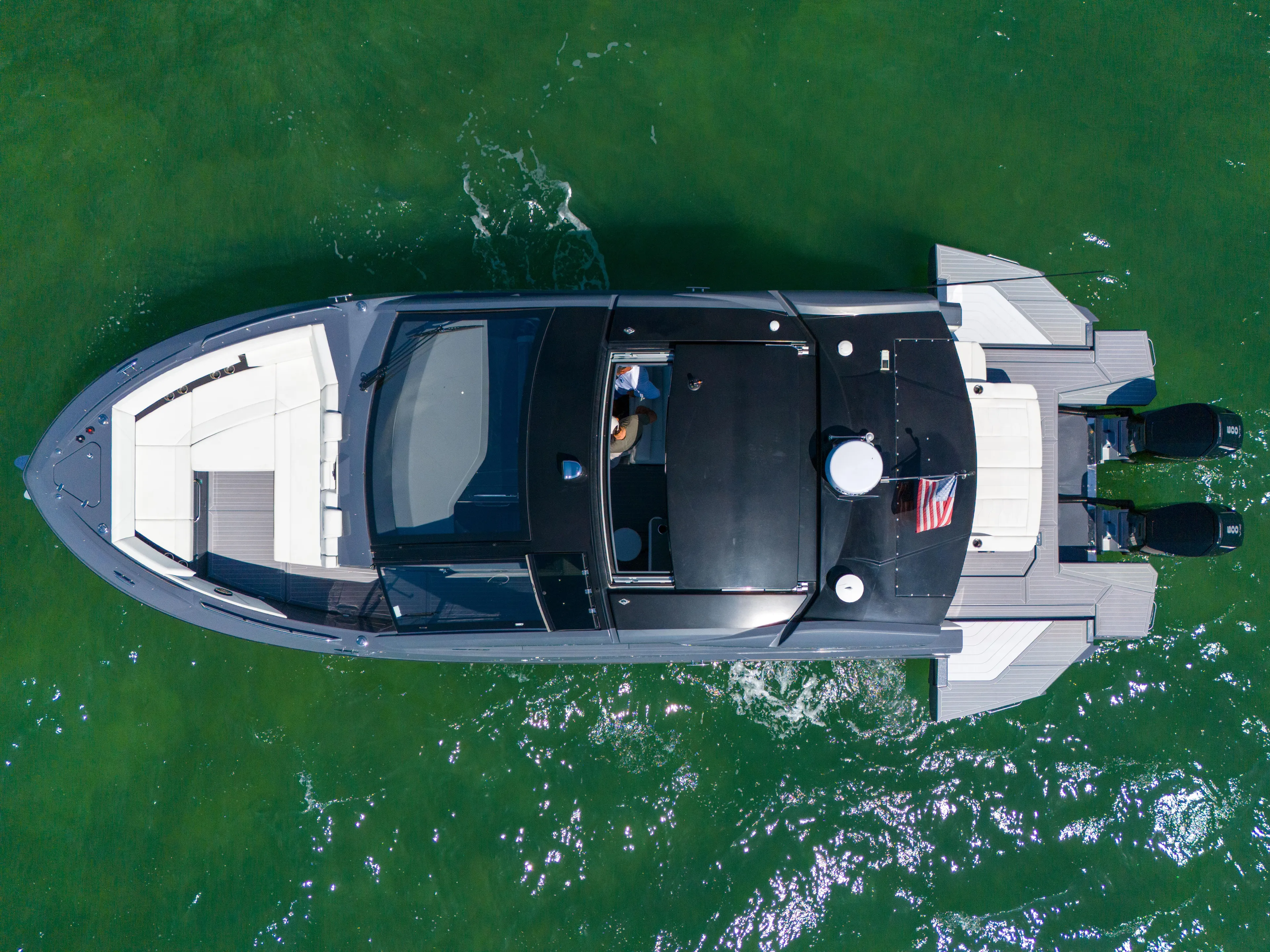  Yacht Photos Pics 2023 Cruisers Yachts 42 GLS OB on green water, aerial view.