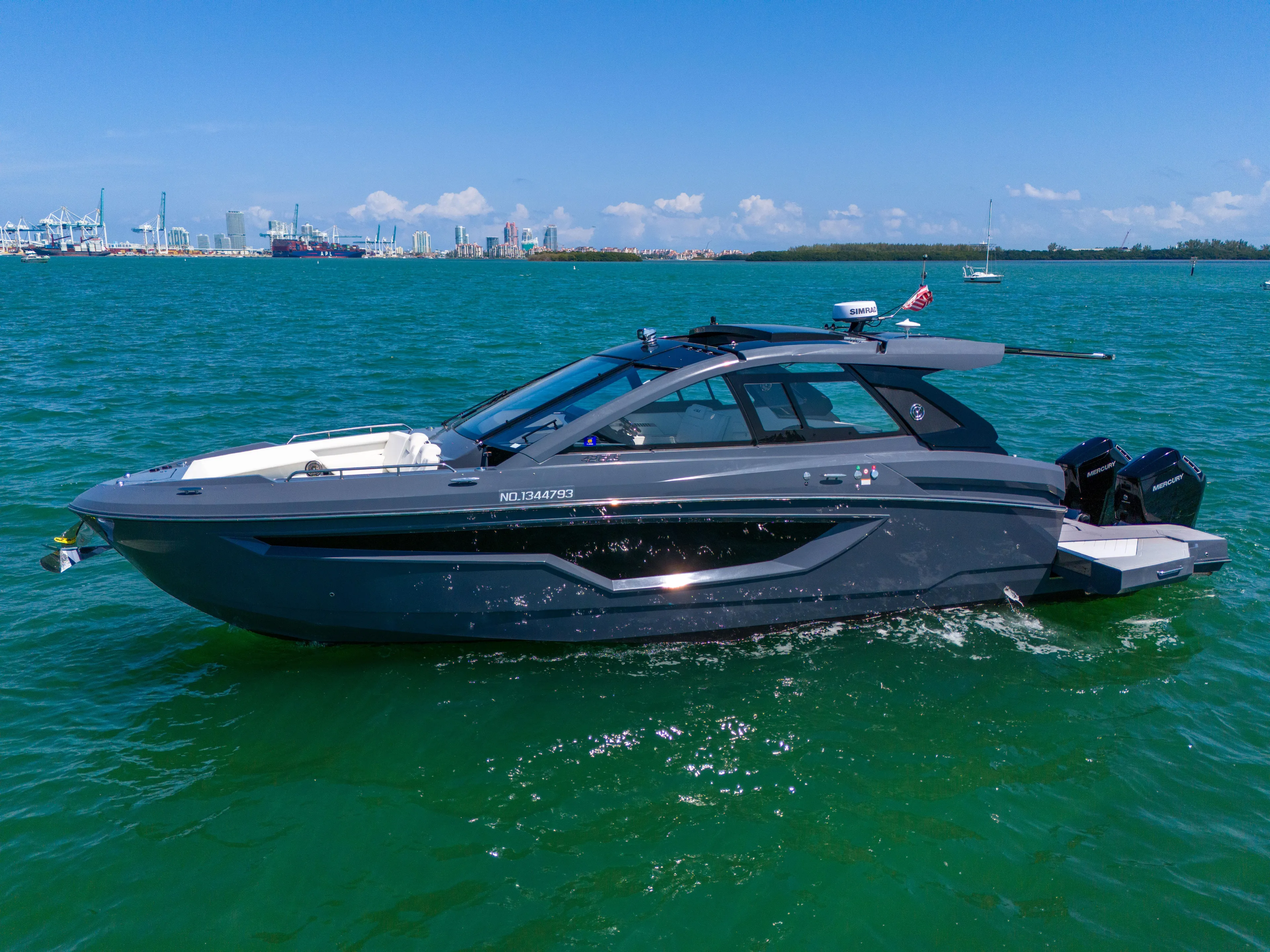  Yacht Photos Pics 2023 Cruisers Yachts 42 GLS OB on vibrant blue water, showcasing sleek design.