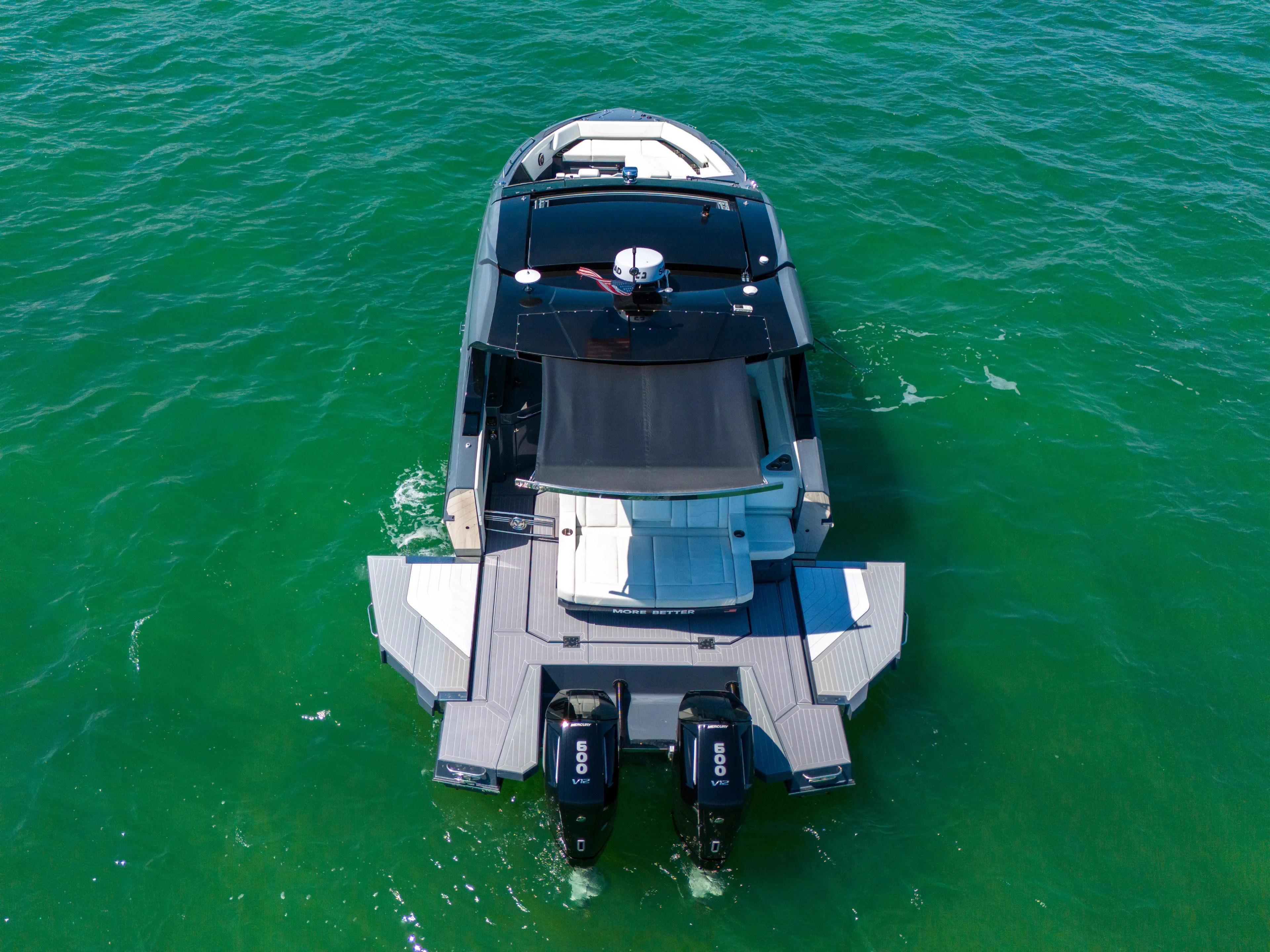  Yacht Photos Pics 2023 Cruisers Yachts 42 GLS OB on clear green water, rear view.