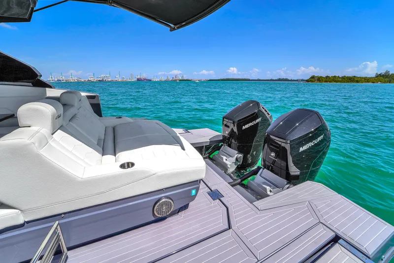  Yacht Photos Pics 2023 Cruisers Yachts 42 GLS OB on turquoise water, featuring dual Mercury outboard engines.